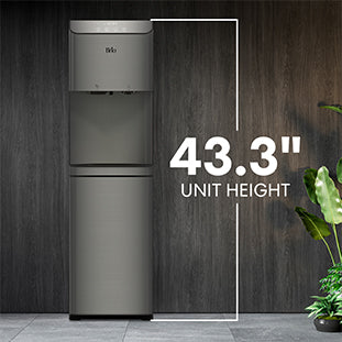 A silver water dispenser stands against a dark wood wall with a houseplant nearby. Text on the right reads 43.3\ Unit Height, indicating the height of the dispenser.